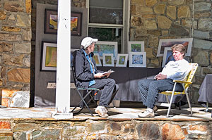 Julia Flanagan photographs displayed on the front porch of the Stone House Visitor Center lawn